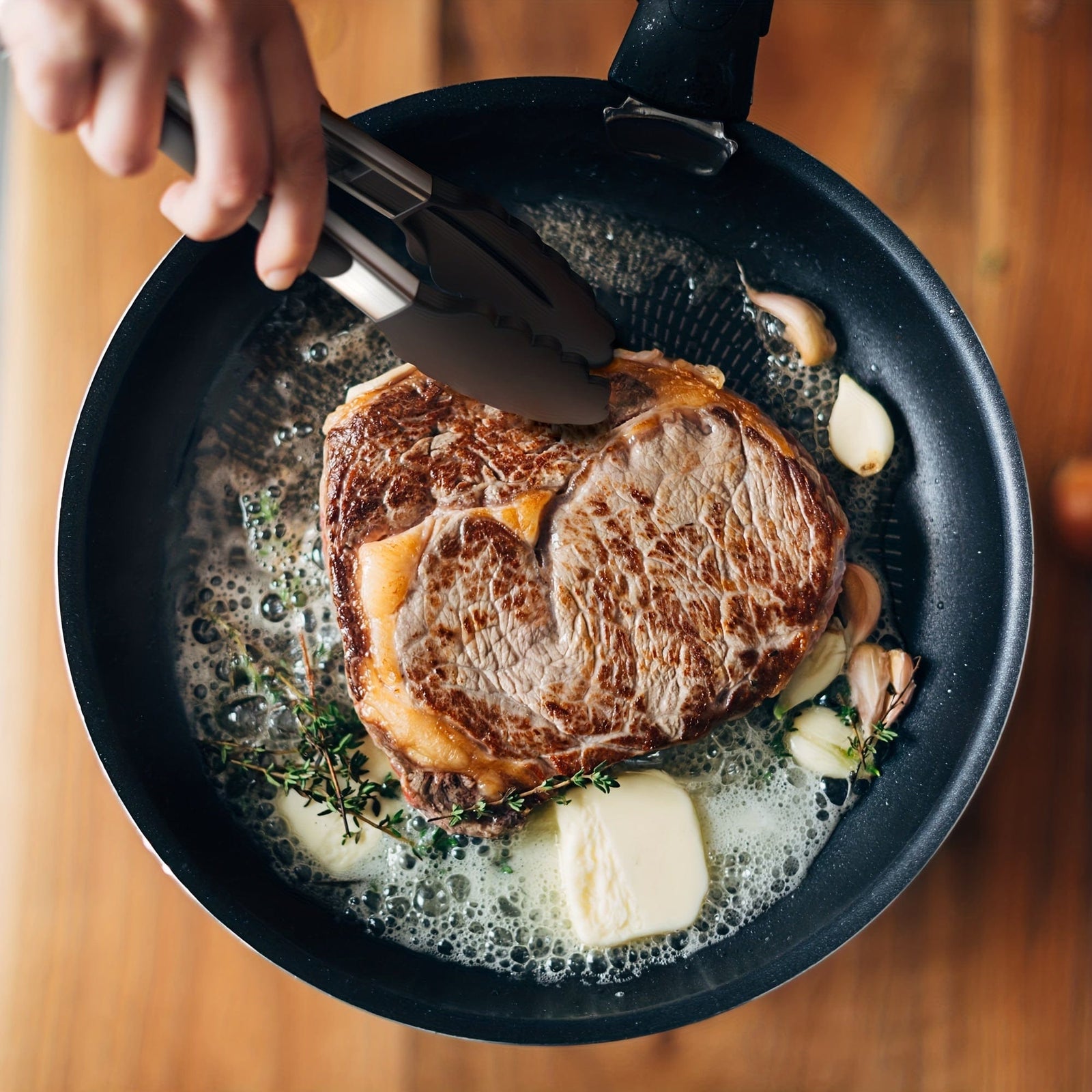 Kökszongler i rostfritt stål med svarta silikonspetsar