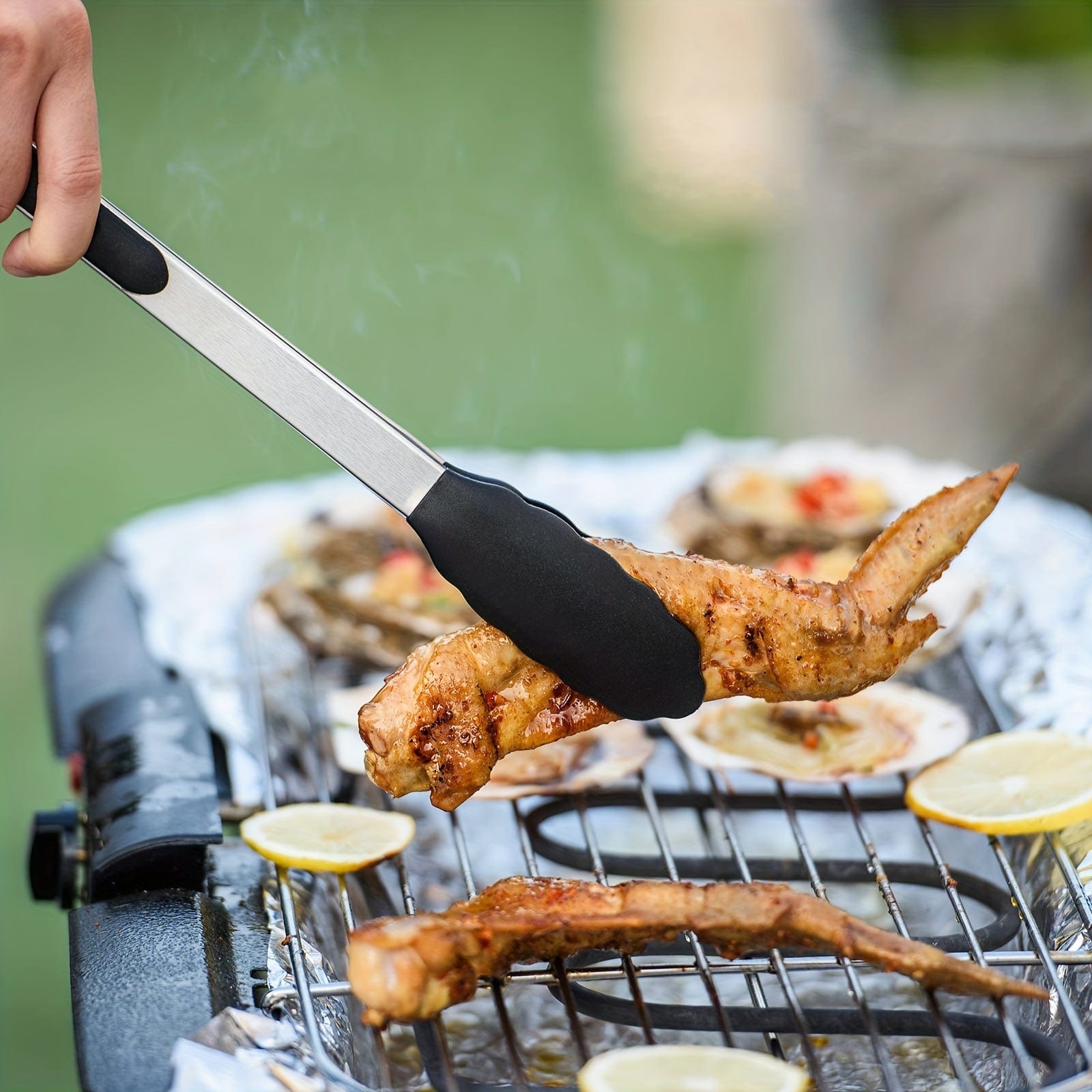 Kökszongler i rostfritt stål med svarta silikonspetsar